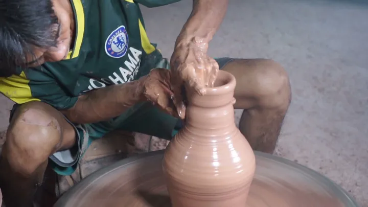 Artisan throwing a clay vase on the potter’s wheel