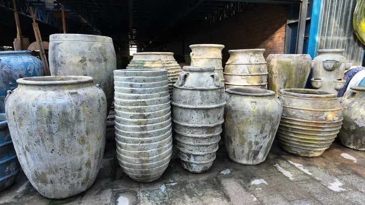 Weathered grey stone-finish jars and stacked pots